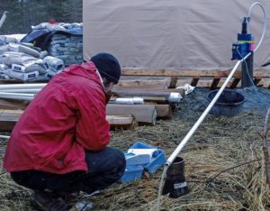 Terrasat engineer conducts water quality assessment at a remote site for mine permitting